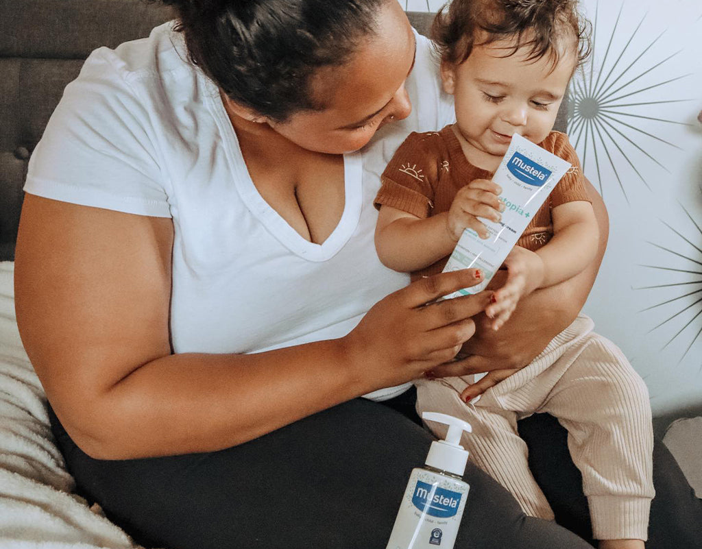 Mom using gentle skincare to help baby dry skin on face