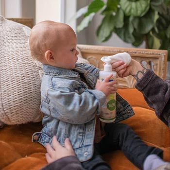 Mom using Mustela products on baby