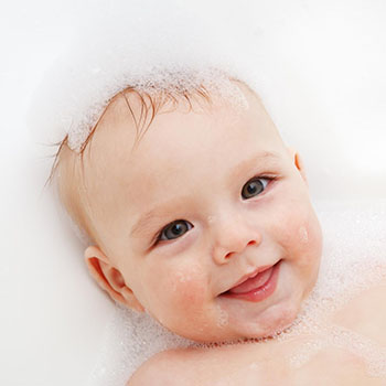 baby having its hair washed to help with baby hair loss