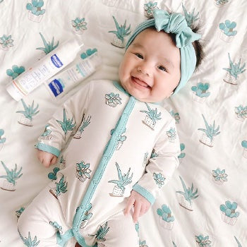 Baby with skin care products that help with baby heat rash