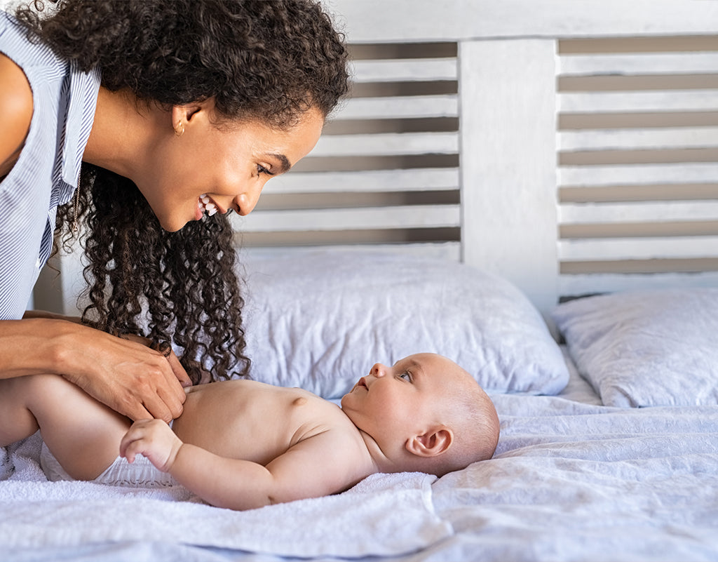 Mom about to change a baby poop diaper