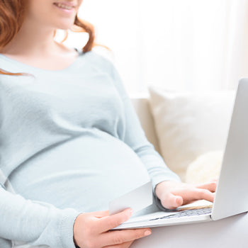 Mom doing an online baby registry checklist