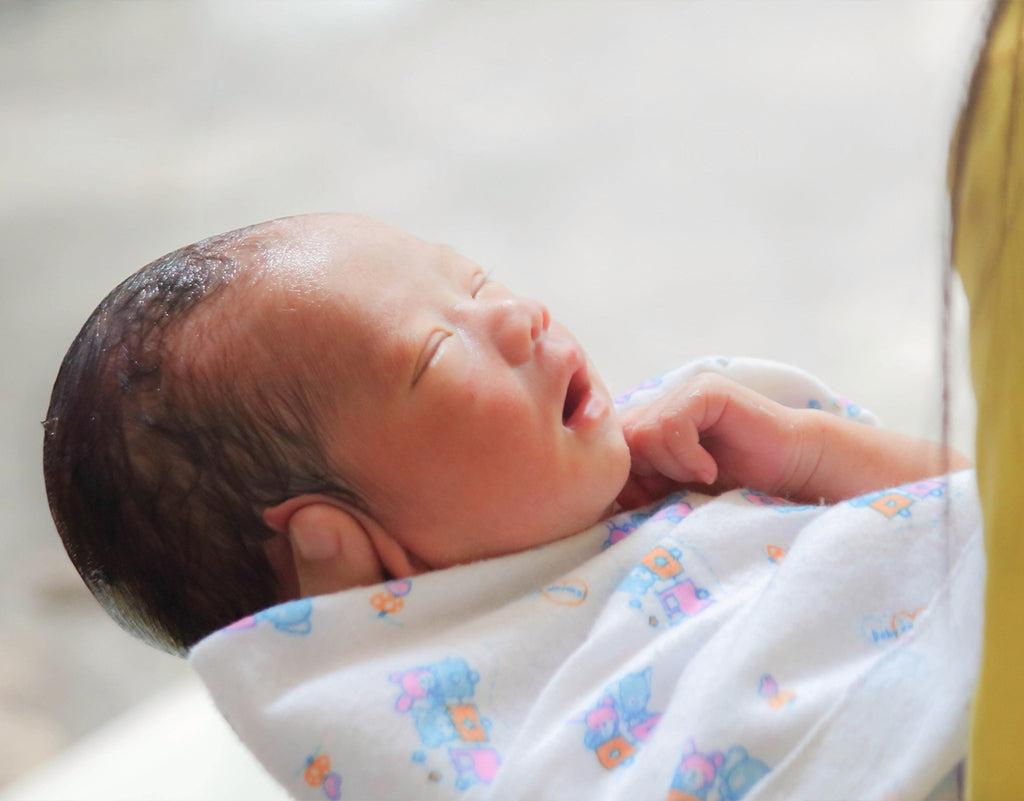 Newborn wrapped up in a towel after baby's first bath