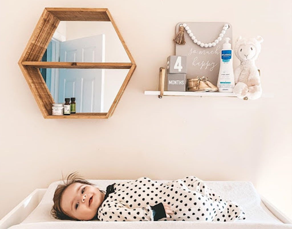 Baby laying on a diaper changing table 