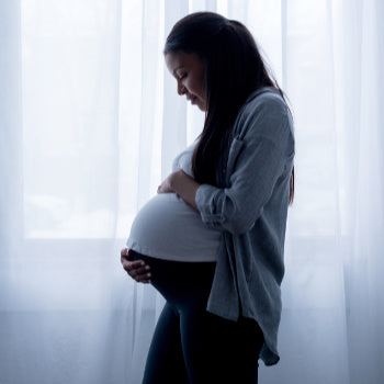 Pregnant woman holding belly