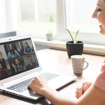 Pregnant woman taking a screenshot of everyone at virtual baby shower