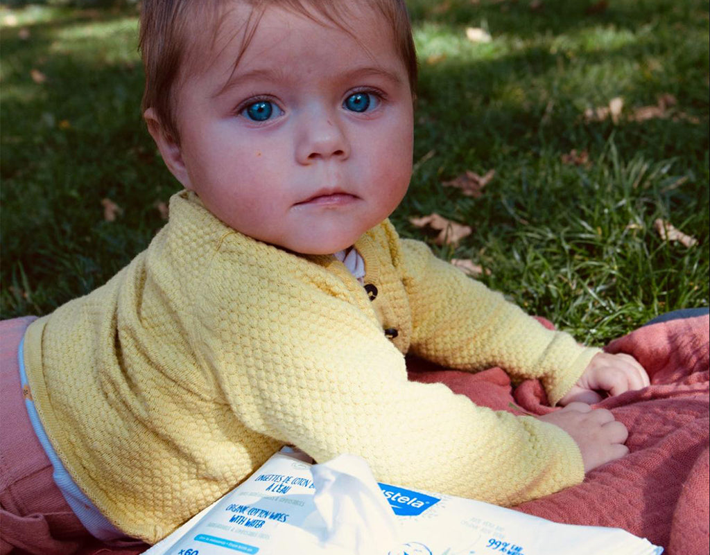 Baby with biodegradable baby wipes