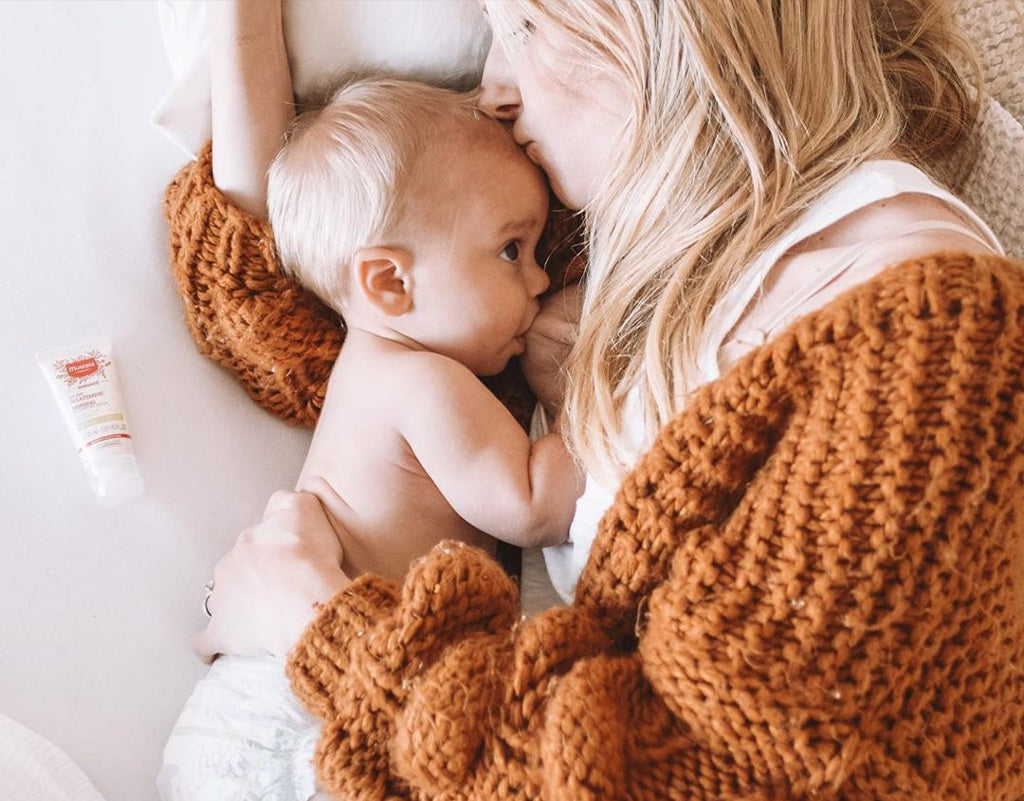 Mom kissing newborn baby