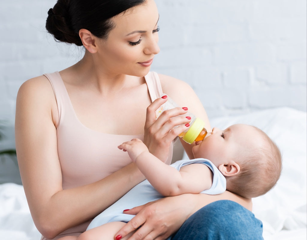 Mom feeding with breast milk that's been stored