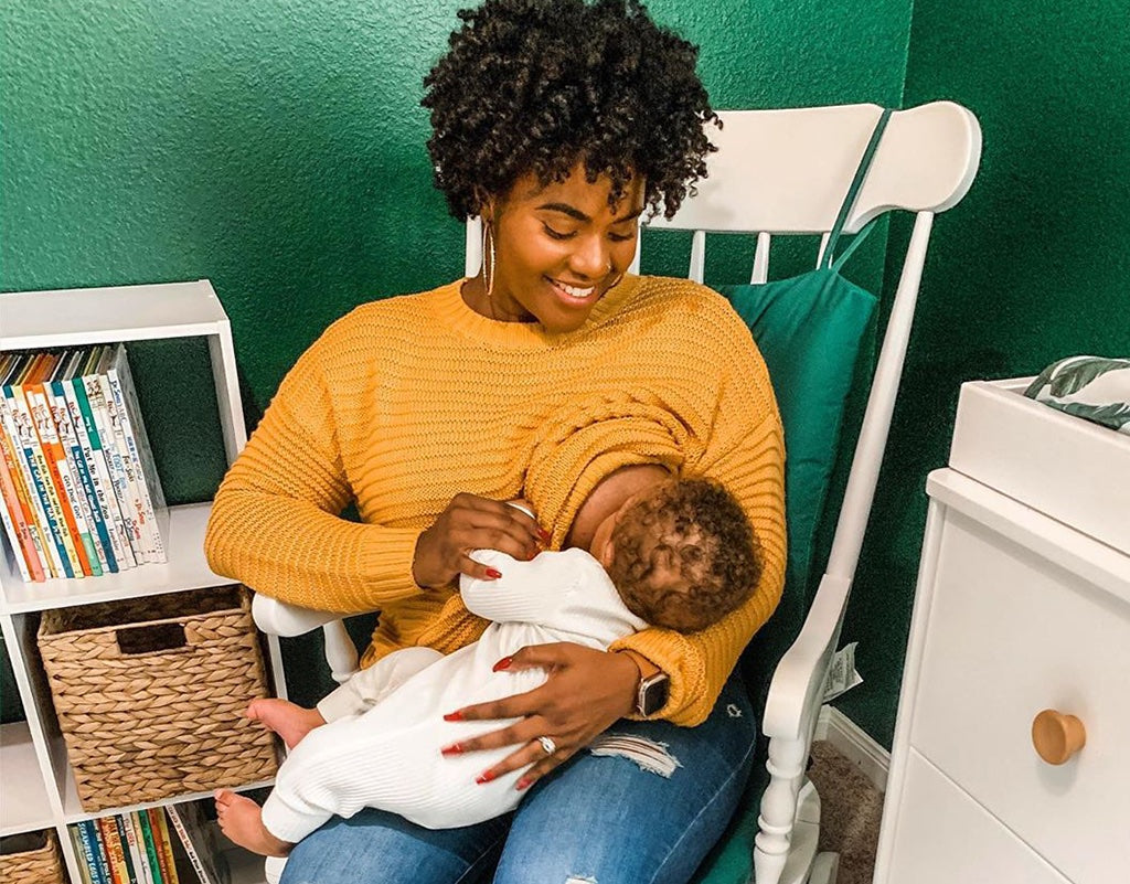 Mom sitting on a rocking chair while breastfeeding