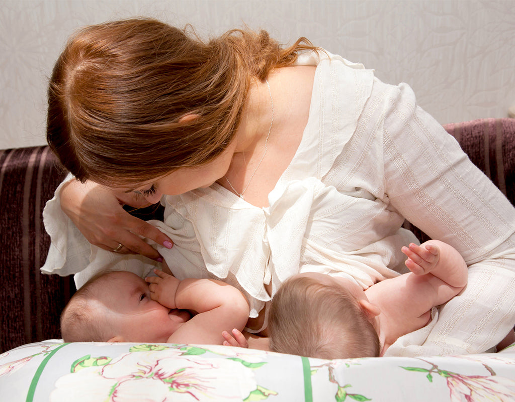 Mom tandem breastfeeding twins