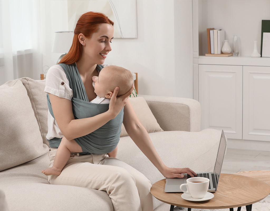 Mom holding baby in sling after cluster feeding