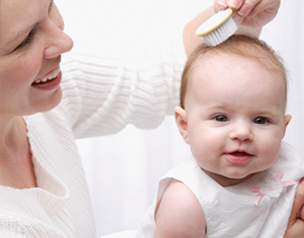 Mom brushing baby's hair