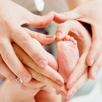 parents' and baby's hands