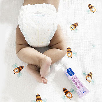 baby's diapered bottom lying next to Diaper Rash Cream