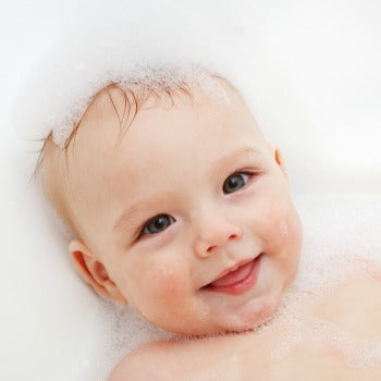 Baby with eczema taking a bath