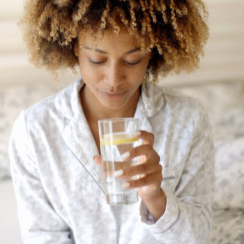 Woman drinking water as part of a healthy pregnancy diet