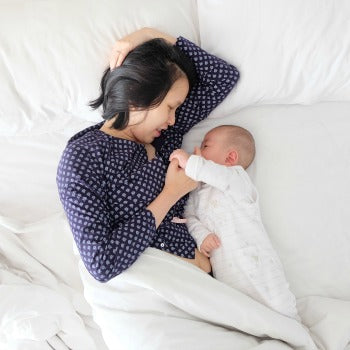 Mom breastfeeding in a special position to avoid sore nipples