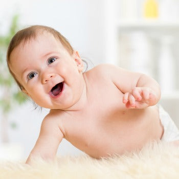 happy baby crawling on fuzzy rug