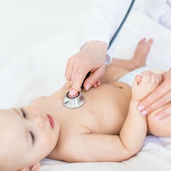 baby on care table at doctor visit