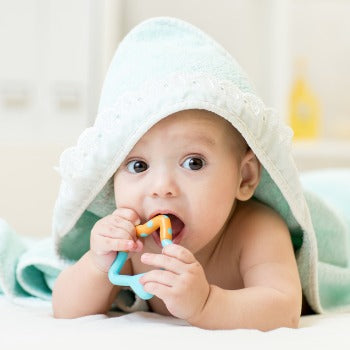 baby in towel playing