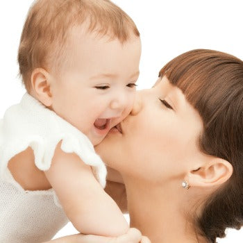 mother kissing happy baby