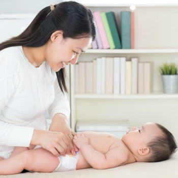 mother changing baby's diaper