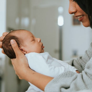 new mother practicing breastfeeding tips