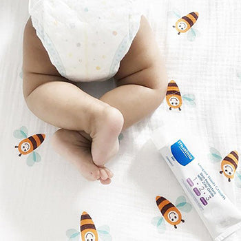 baby crawling near diaper bag essentials