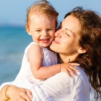 mother and baby relaxing at the beach