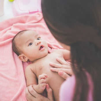 mother applying coconut oil as natural eczema treatment