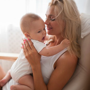 mother and baby bonding in rocking chair