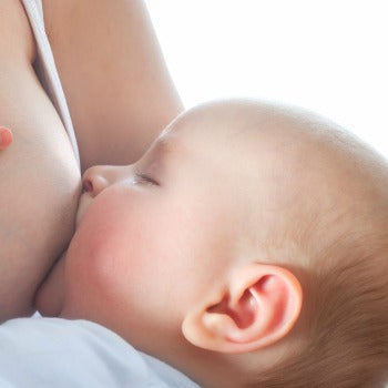 close up of mother breastfeeding newborn baby