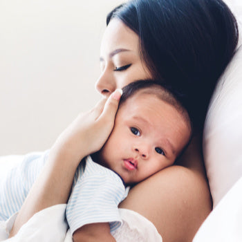 mom comforting baby after learning parenting tips