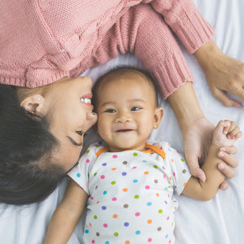 Happy mom with baby during postpartum recovery