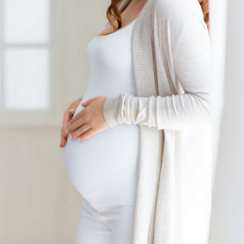 Pregnant woman contemplating her prenatal visit schedule