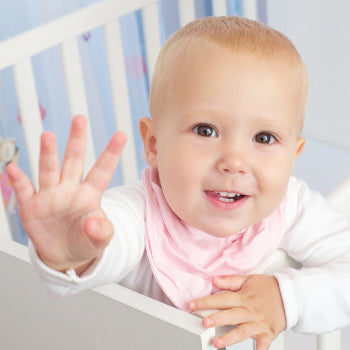 baby girl awake in her crib during the two year sleep regression