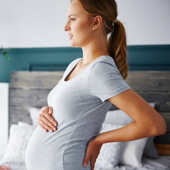 Woman with back aches in her third trimester