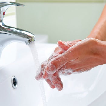 parent washing hands before applying emollient