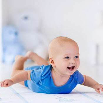 happy baby enjoying tummy time