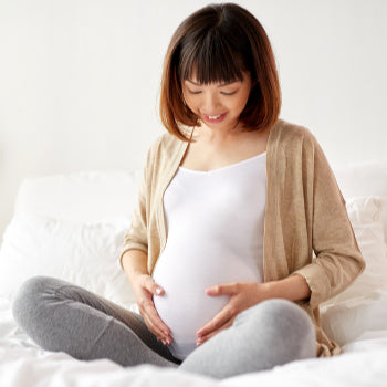 Pregnant woman holding belly