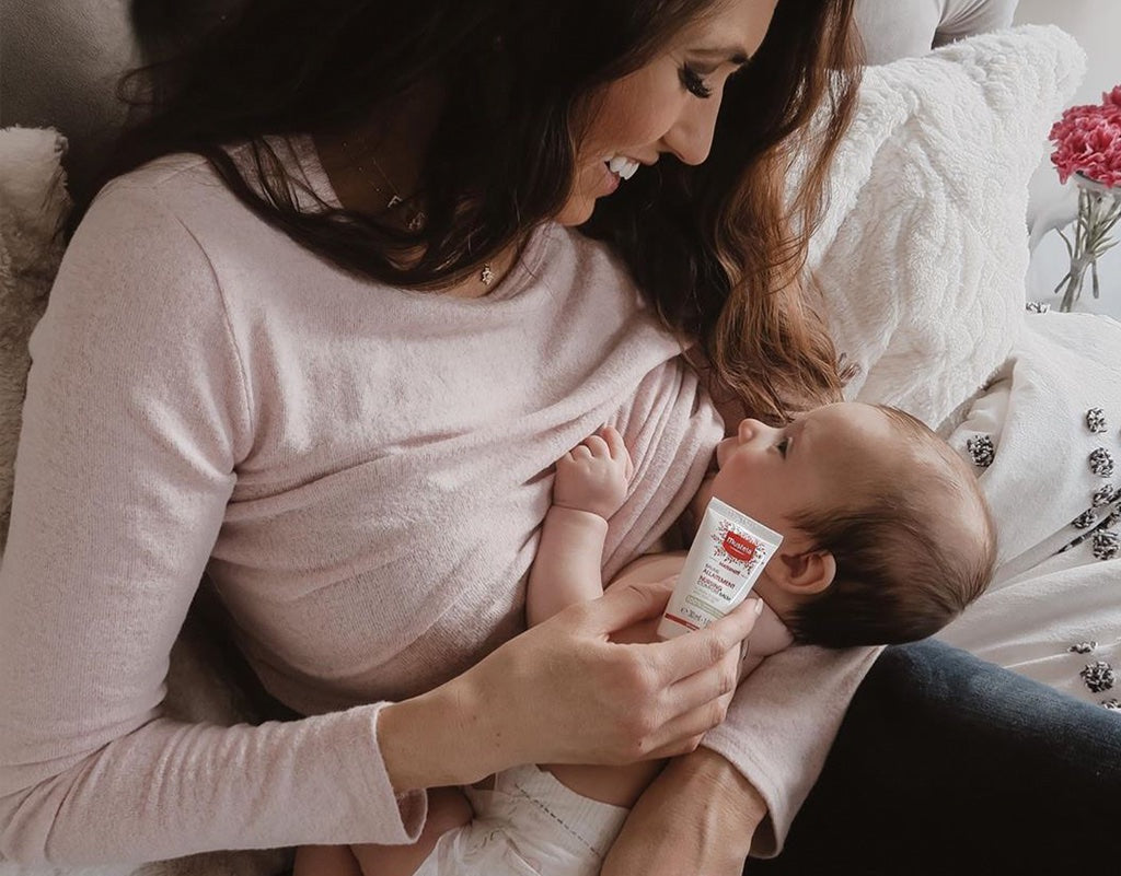 Mom using nipple cream