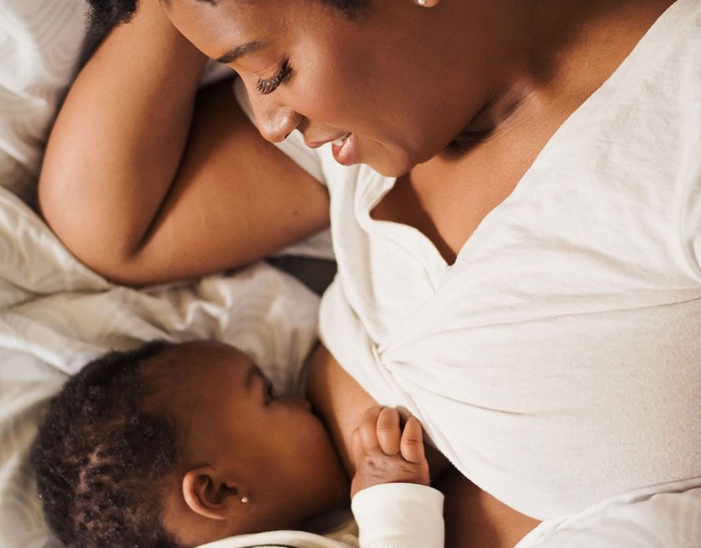 Mom breastfeeding baby while laying down