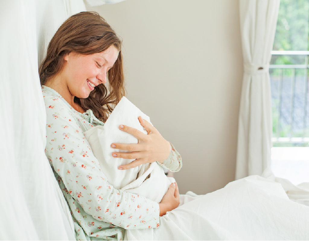 Mom experiencing fourth trimester with newborn 
