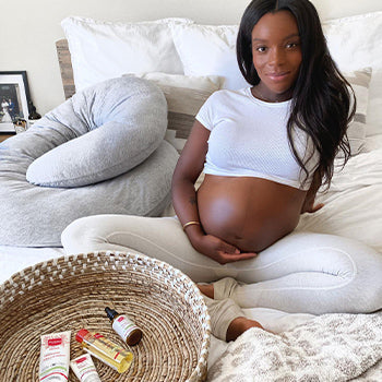 Woman using stretch marks oil on her belly