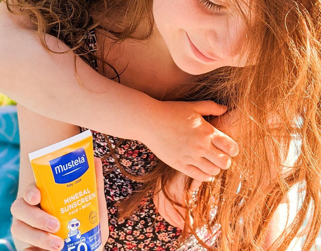 Kid holding mineral sunscreen for face and body