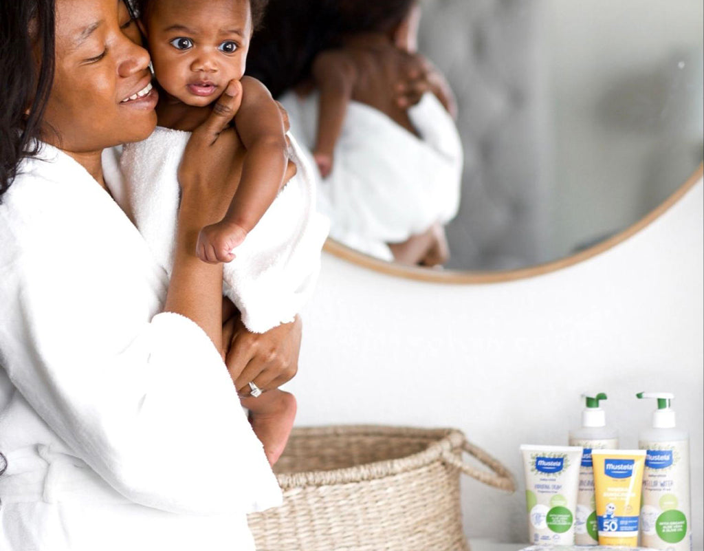 Mom holding baby after bath time