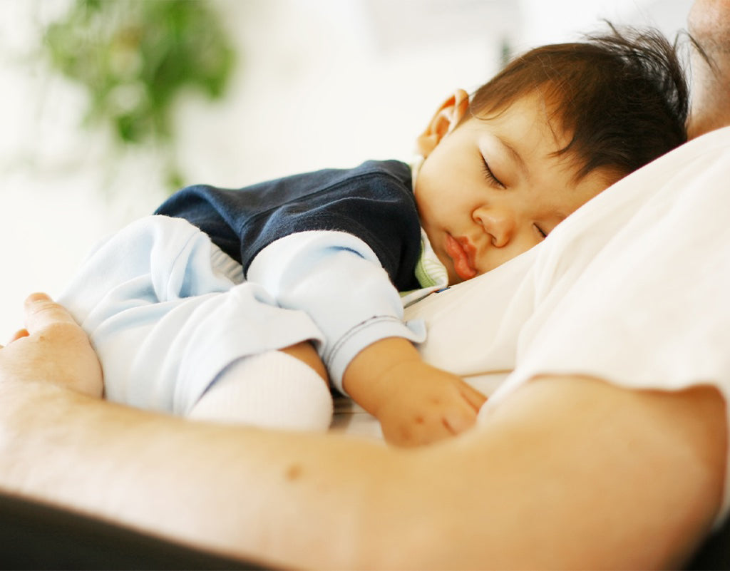 Baby sleeping on dads chest