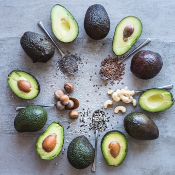 Avocados in a circle with nuts and seeds