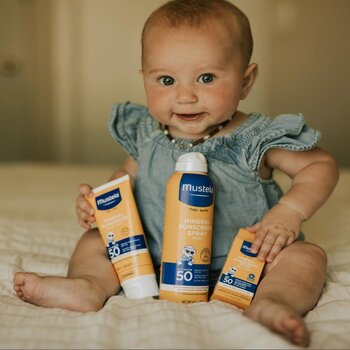 Baby holding hypoallergenic sunscreen